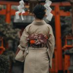 Woman in traditional kimono at Fushimi Inari Shrine, Kyoto, Japan. Cultural and artistic scene.
