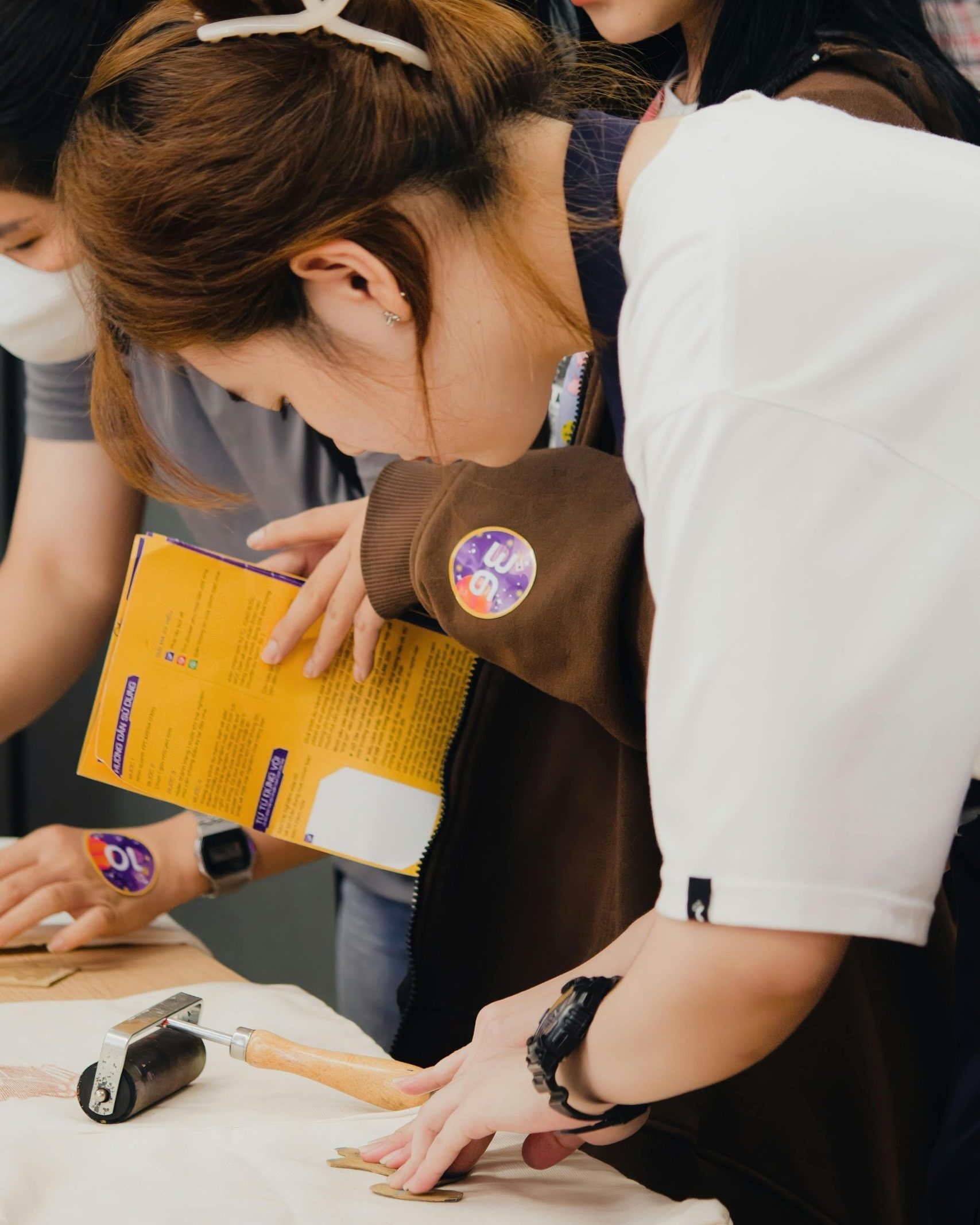 Participants engaging in a DIY craft workshop in Cần Thơ, Việt Nam, using various tools and materials.
